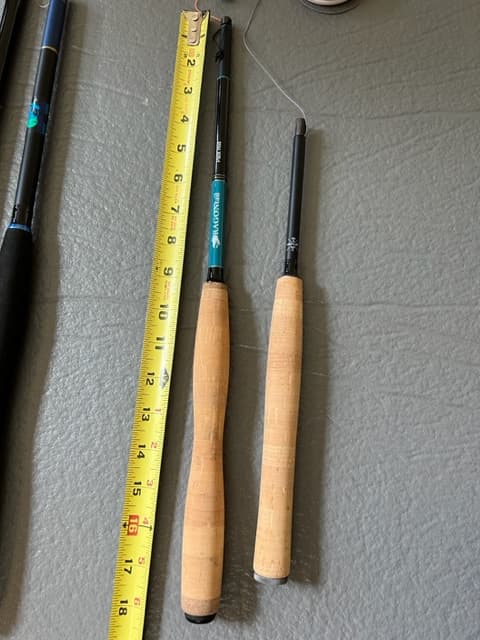 Two fly-fishing rods with a tape measure showing length